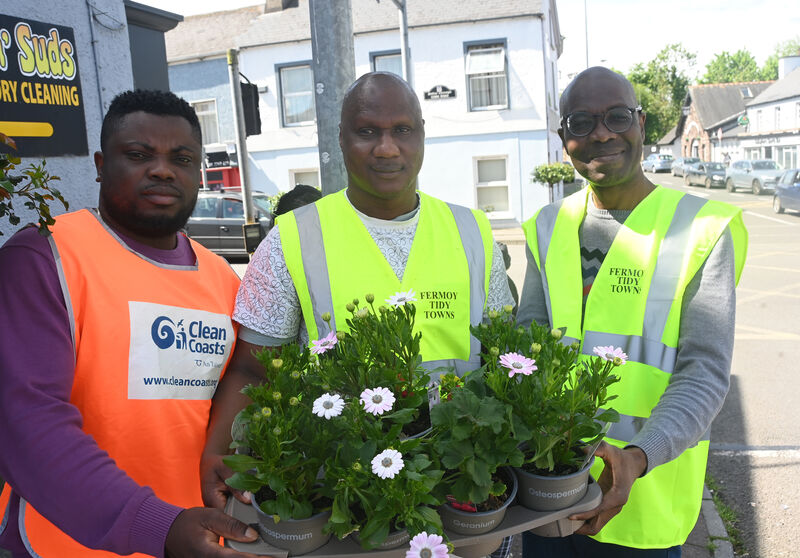 Volunteers Oluwasegun, Samuel and Delybaas pose together for a photo before heading out filling plant pots in Fermoy. Pic: Larry Cummins