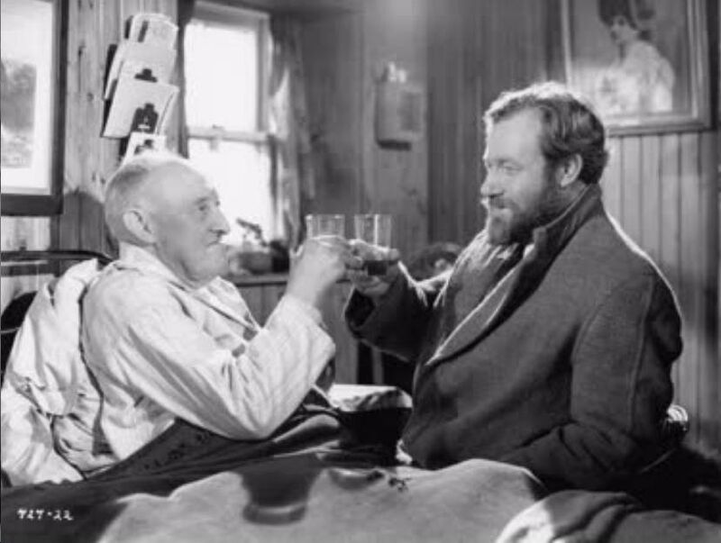 The oldest resident sharing a dram with his doctor in Whisky Galore. The oldest resident sharing a dram with his doctor in Whisky Galore.