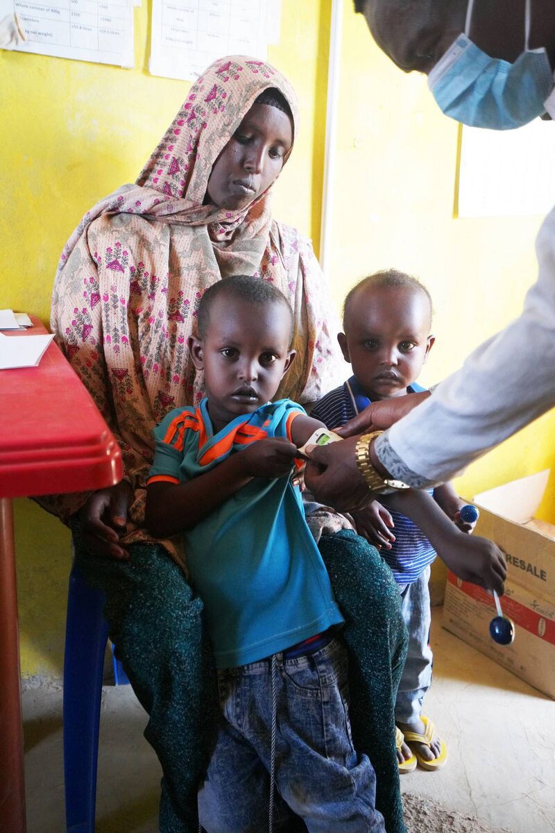 Abdiwasa Mahamed Abdi (4) being measured a MUAC band, as he attends a malnutrition screening at Legahida, Ethiopia, with his mother Nimo and his brother Abdirahaman (3). Photo: Conor O'Donovan/Concern Worldwide