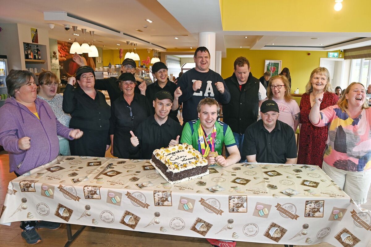 Colm Monahan, a member of the staff at Chapel Gate Café, Ballincollig, run by the Brothers of Charity, during a celebration in his honour in the café on his return with a men's singles gold medal for badminton at the Special Olympics World Games pictured with the café staff and manager Anne Cahill. Picture: Denis Minihane.