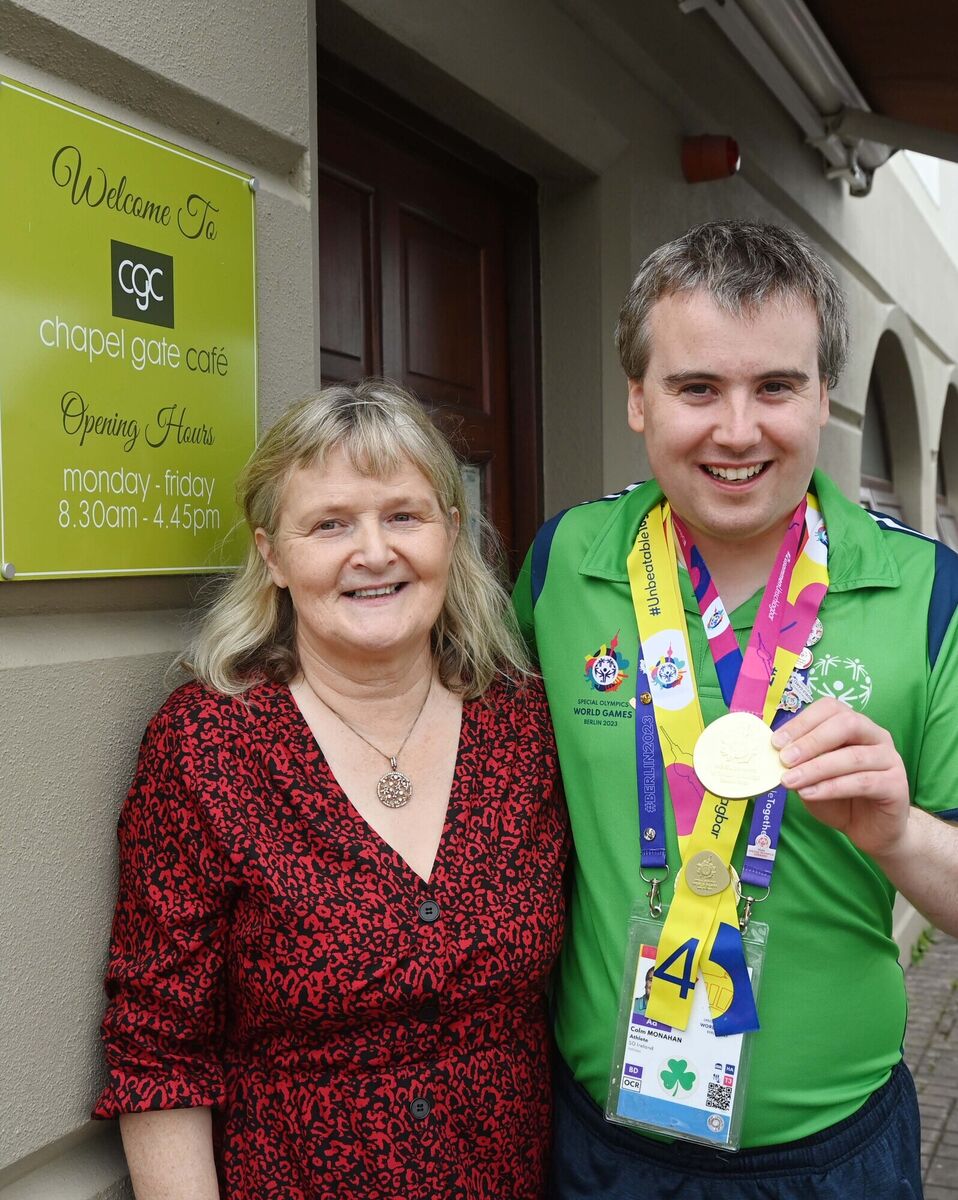 Colm Monahan, a member of the staff at Chapel Gate Café, Ballincollig, run by the Brothers of Charity, during a celebration in his honour at the café on his return with a men's singles gold medal for badminton at the Special Olympics World Games pictured with the café manager Anne Cahill. Picture: Denis Minihane.