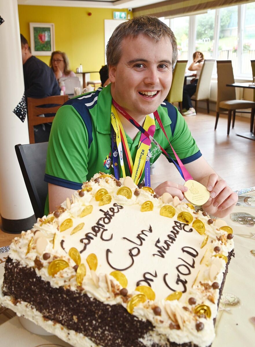Colm Monahan, a member of the staff at Chapel Gate Café, Ballincollig, run by the Brothers of Charity, during a celebration in his honour in the café on his return with a men's singles gold medal for badminton at the Special Olympics World Games.