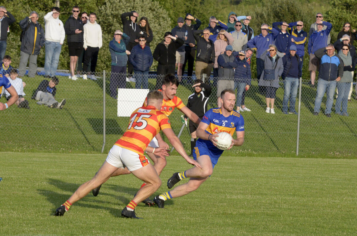 Carrigaline's Jack Kelly is tackled by Newcestown's Gearoid O'Donovan and Trevor Horgan. Picture: Denis Boyle