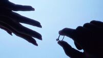 Man's Hand Placing a Ring on a Woman's Hand