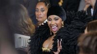 Cardi B dons dramatic feather-like bolero at Paris Fashion Week
