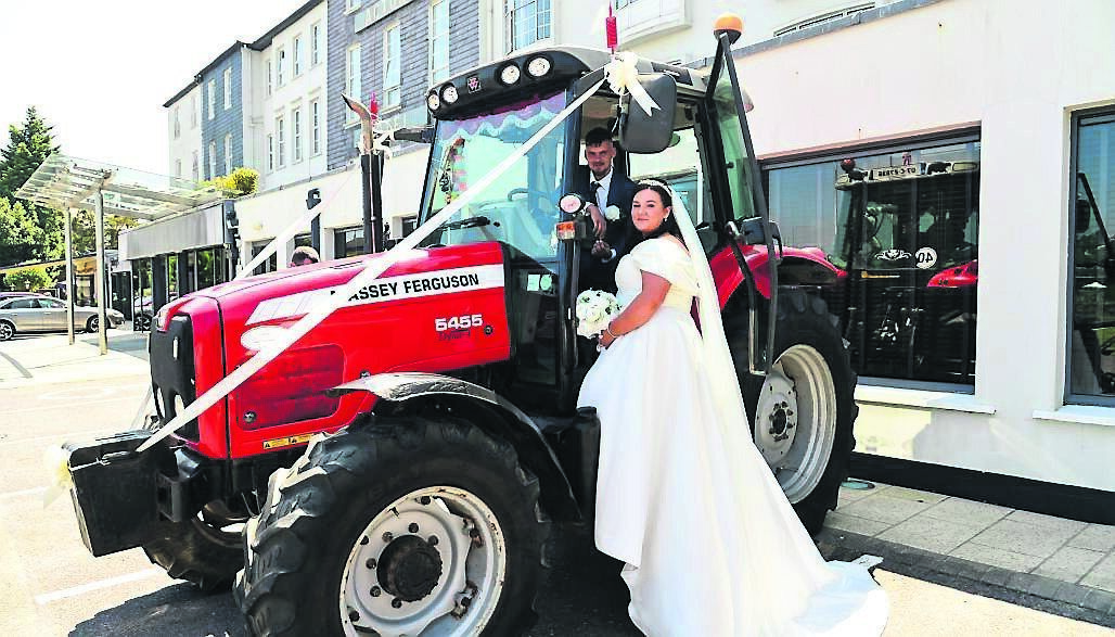 The bride and groom with the Massey Ferguson. They had their wedding and reception at Actons Hotel in Kinsale, the town where they both grew up and still live today.