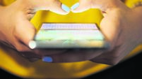 Woman Typing Phone Message On Social Network At Night