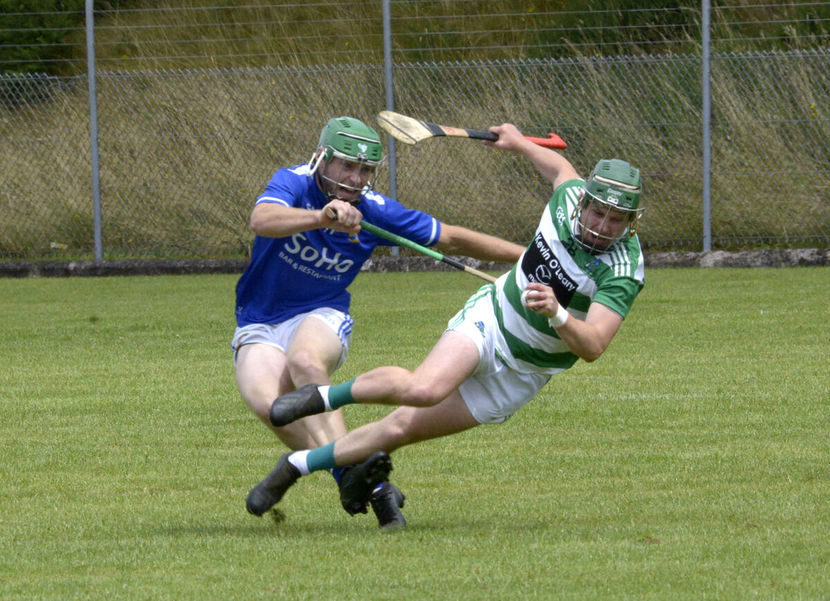 Valley Rovers' Jack Walsh ships a hit from Ballinhassig's Conor Desmond. Picture: Denis Boyle