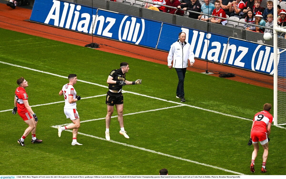 Rory Maguire of Cork scores his side's goal over the head of Derry goalkeeper Odhran Lynch. Picture: Brendan Moran/Sportsfile