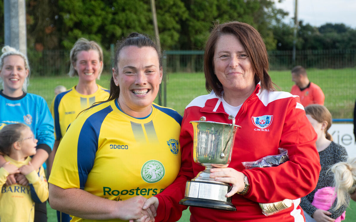 Douglas Hall captain Maggie Duncliffe receives the CWSSL Premier Division league trophy from Maria McGrath. Picture: Howard Crowdy