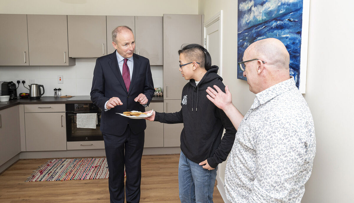 Tánaiste Micheál Martin pictured with new homeowners Harry and Martin Ryan at the LDA’s Clonmore development in Mallow, Cork. Photo: Gerard McCarthy