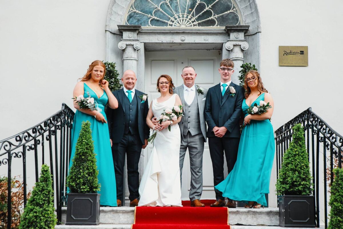 The couple on the steps of Ditchley House, at the Radisson Blu in Little Island, where they were married and had their wedding reception.