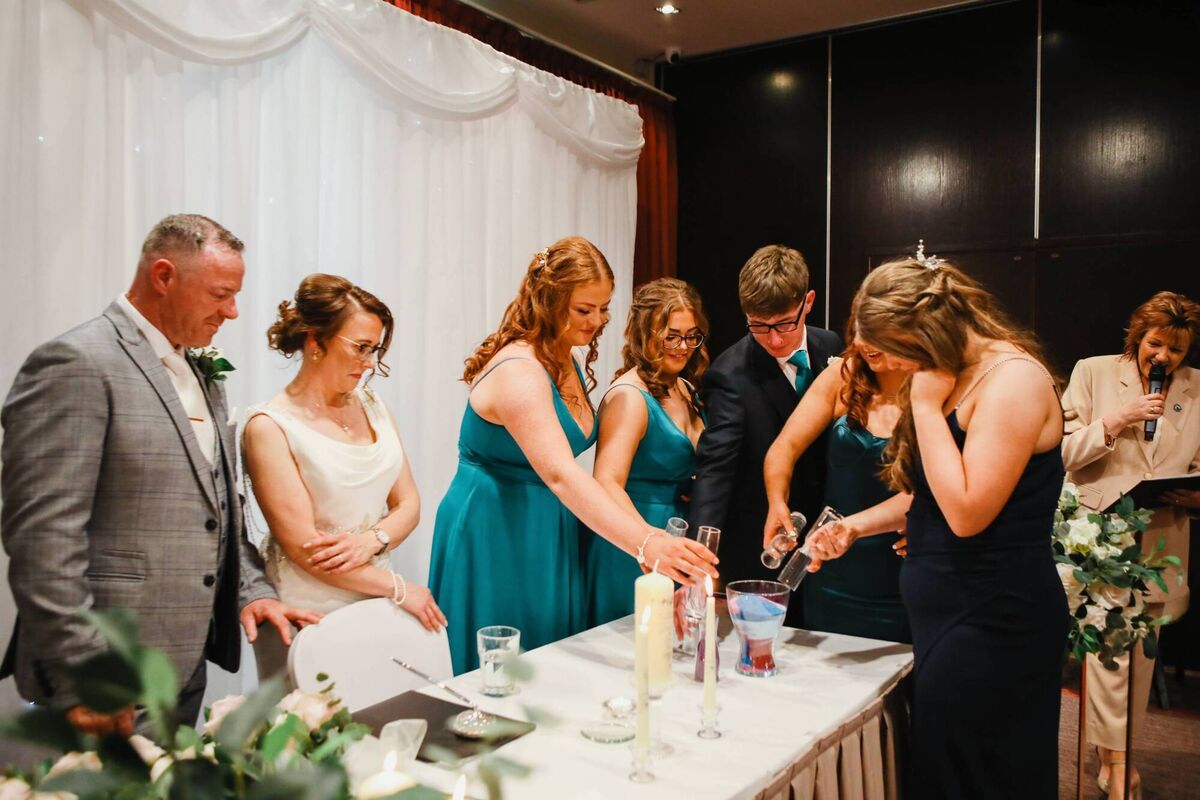 Liam, Danielle and their blended family, taking part in the sand ceremony.