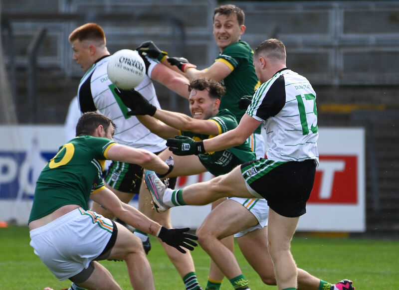 Alan O'Hare of Douglas kicks a point despite the attentions of St Michael's duo Andrew Murphy and Luke Carroll. Picture: Eddie O'Hare