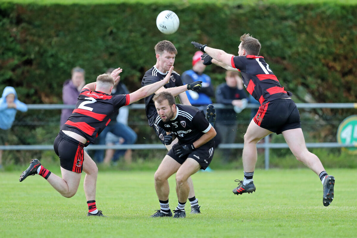 Mikey Browne and Barry O'Connor, Newmarket, try to block the shot of Sean O'Sullivan, Kiskeam, with Jack O'Connor, ducking out of the way. Picture: Jim Coughlan Mikey Browne and Barry O'Connor, Newmarket, try to block the shot of Sean O'Sullivan, Kiskeam, with Jack O'Connor, ducking out of the way. Picture: Jim Coughlan