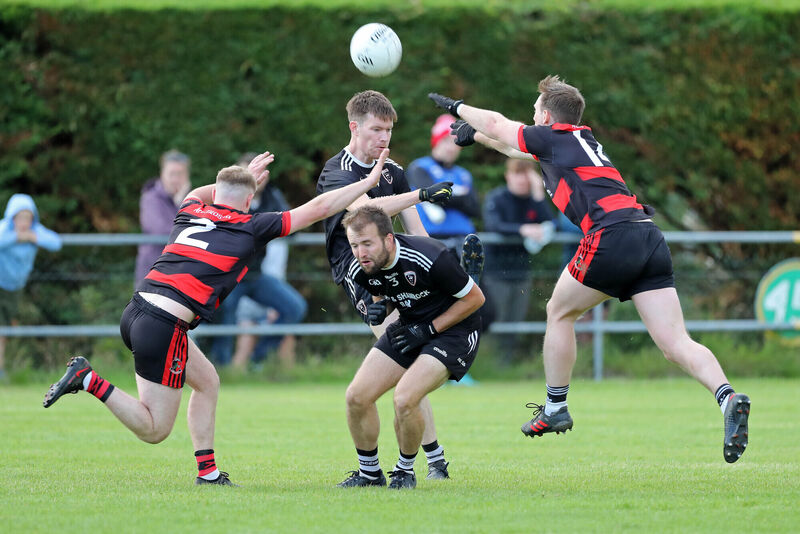  Mikey Browne and Barry O'Connor, Newmarket, try to block the shot of Sean O'Sullivan, Kiskeam, with Jack O'Connor, ducking out of the way. Picture: Jim Coughlan