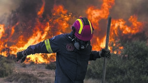 <p class="contextmenu internal_Caption">FLAMING HELL: A wildfire on the Greek island of Rhodes. Searing temperatures and blazes may put people off heading abroad</p>