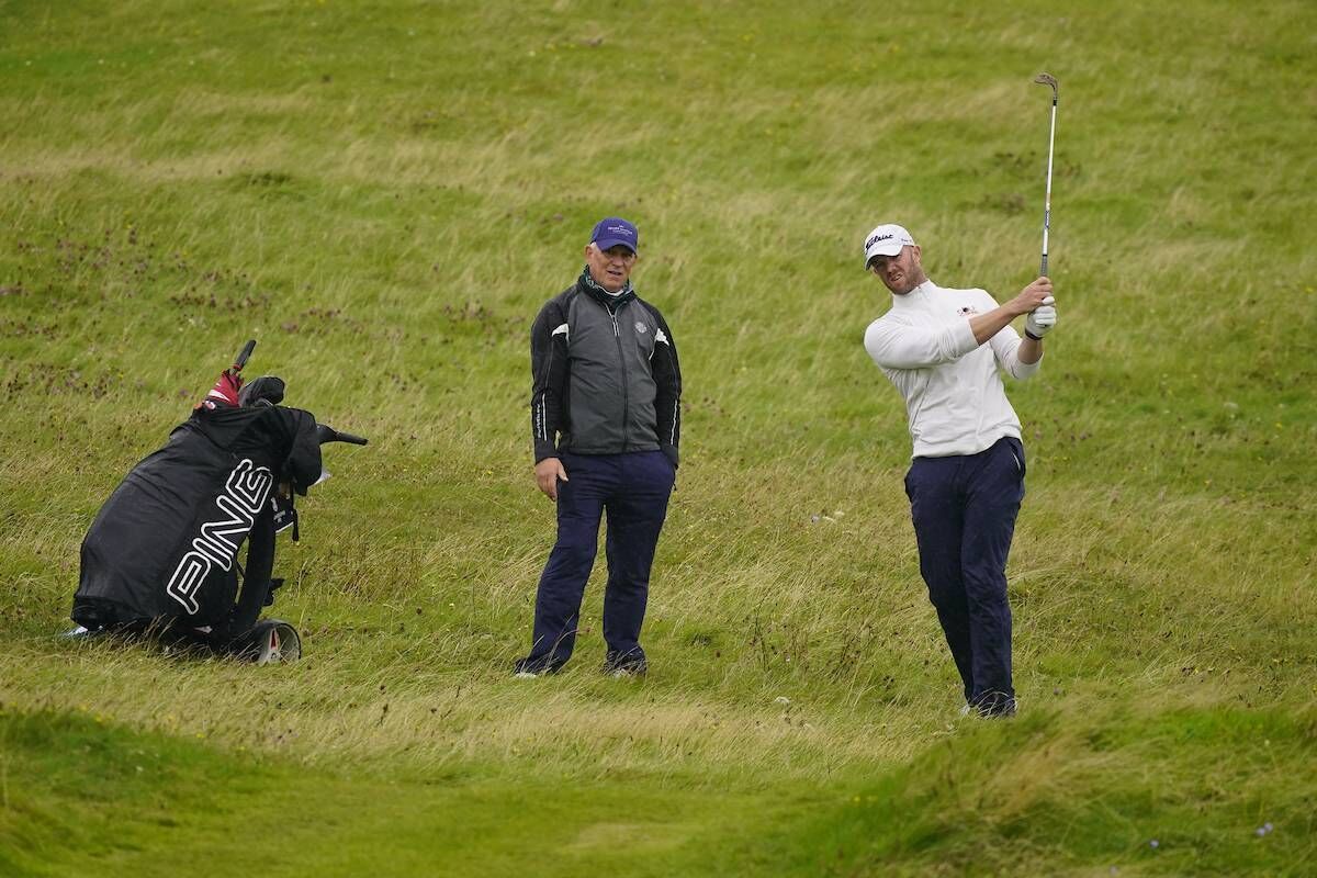 Peter O'Keeffe and his caddie, Karl Bornemann, in action during the final of the South of Ireland Championship at Lahinch. Photo: Thos Caffrey/Golffile
