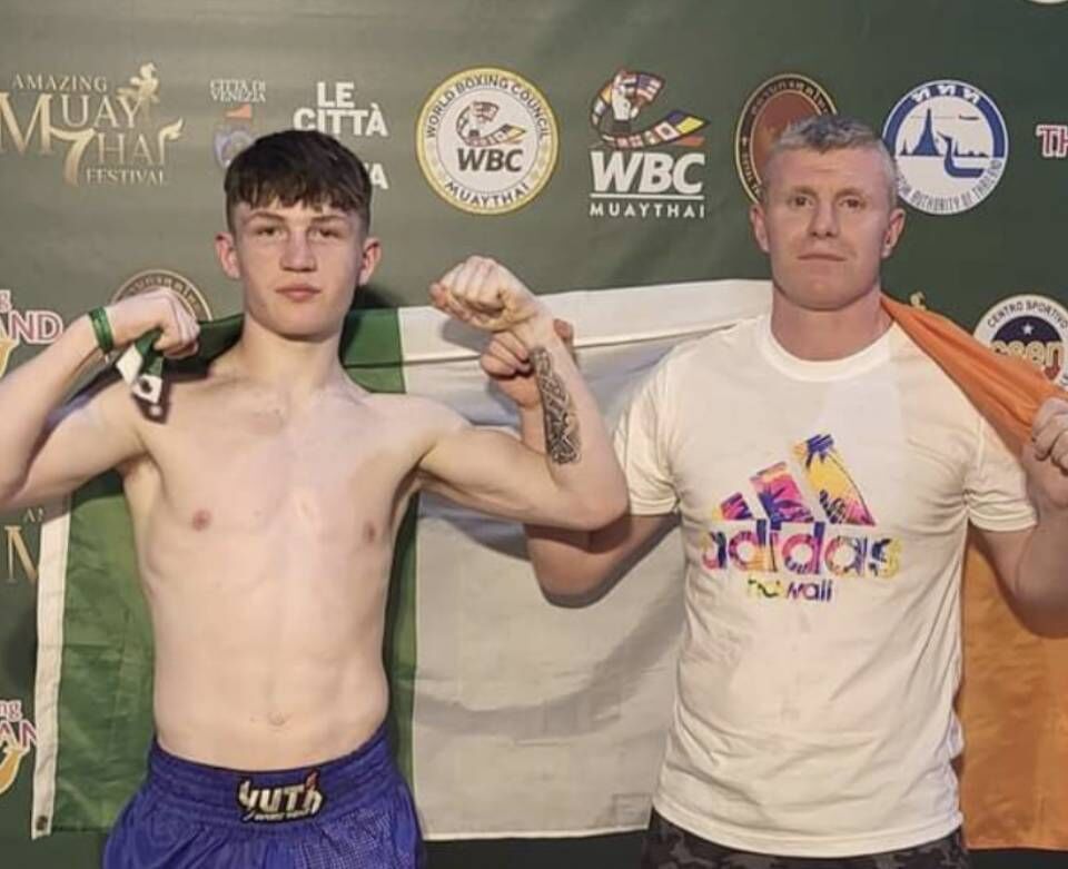 Ballincollig native Colm O’Mahony from the Siam Warriors with coach Martin Horgan after winning gold at the WBC World Championships in Venice. 