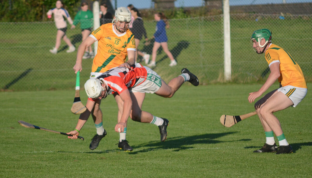 Ballincollig's David O'Sullivan stumbles to the ground as he is challenged by Dungourney's Jack Leahy. Picture: Howard Crowdy