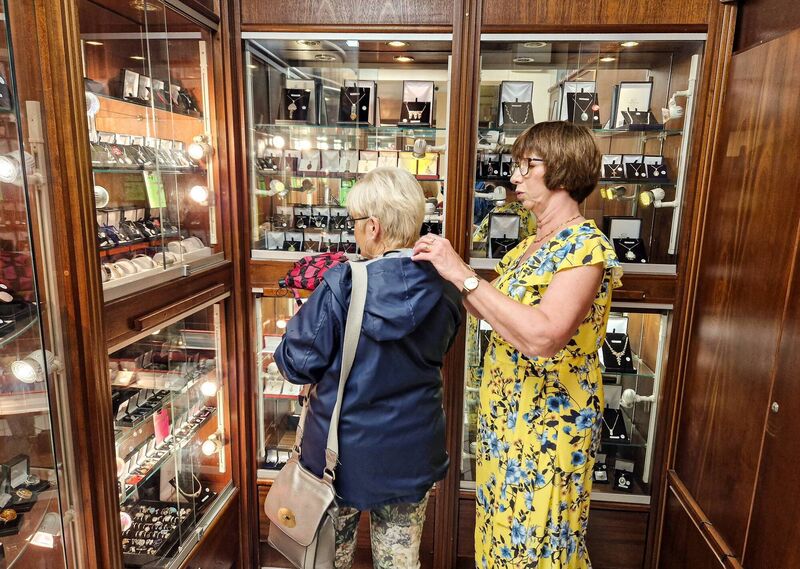  Patricia O’Callaghan helping a customer during the retirement sale at the Liam Lynch shop