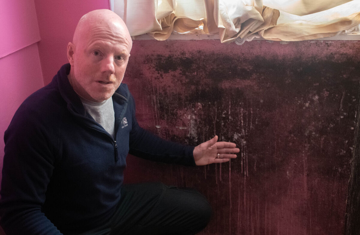William O'Brien, chairman of the Residents Association pictured with one of the walls affected by dampness in one of the houses along Noonan Road. Picture: Howard Crowdy William O'Brien, chairman of the Residents Association pictured with one of the walls affected by dampness in one of the houses along Noonan Road. Picture: Howard Crowdy