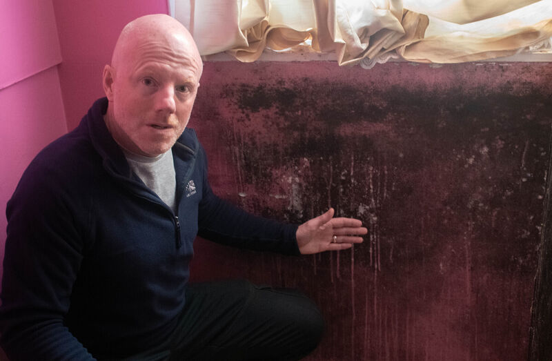 William O'Brien, chairman of the Residents Association pictured with one of the walls affected by dampness in one of the houses along Noonan Road. Picture: Howard Crowdy