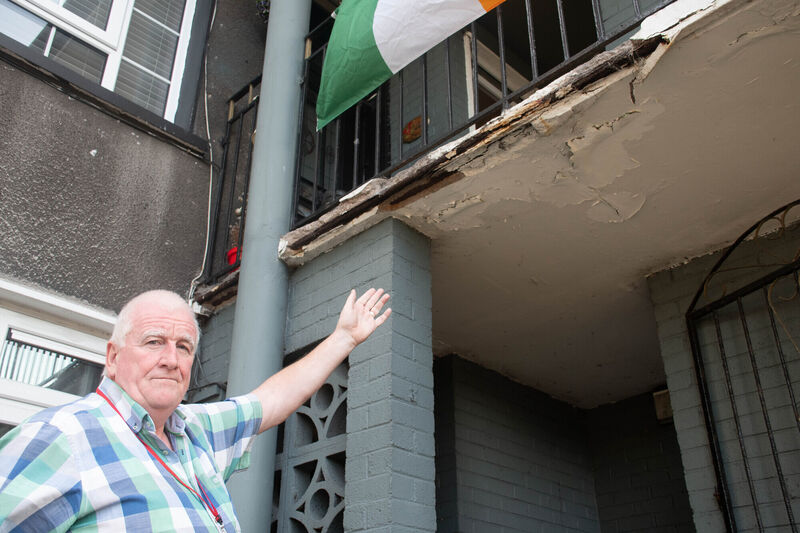 Cllr Paudie Dineen seen with some of the exposed supports on one of the buildings along Noonan Road. Picture: Howard Crowdy