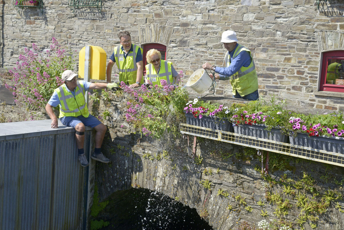 Pictured watering the flowers at the library were members of Clonakilty Tidy towns. Picture Denis Boyle