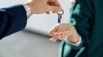 Close-up of a couple receiving key of their new real estate.