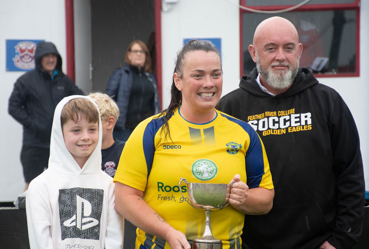 Douglas Hall captain Maggie Duncliffe receives the Steve Quinn Cup from Samuel and Sean Quinn following her teams win over Lakewood in the final which was played in St Colman's Park. Picture: Howard Crowdy