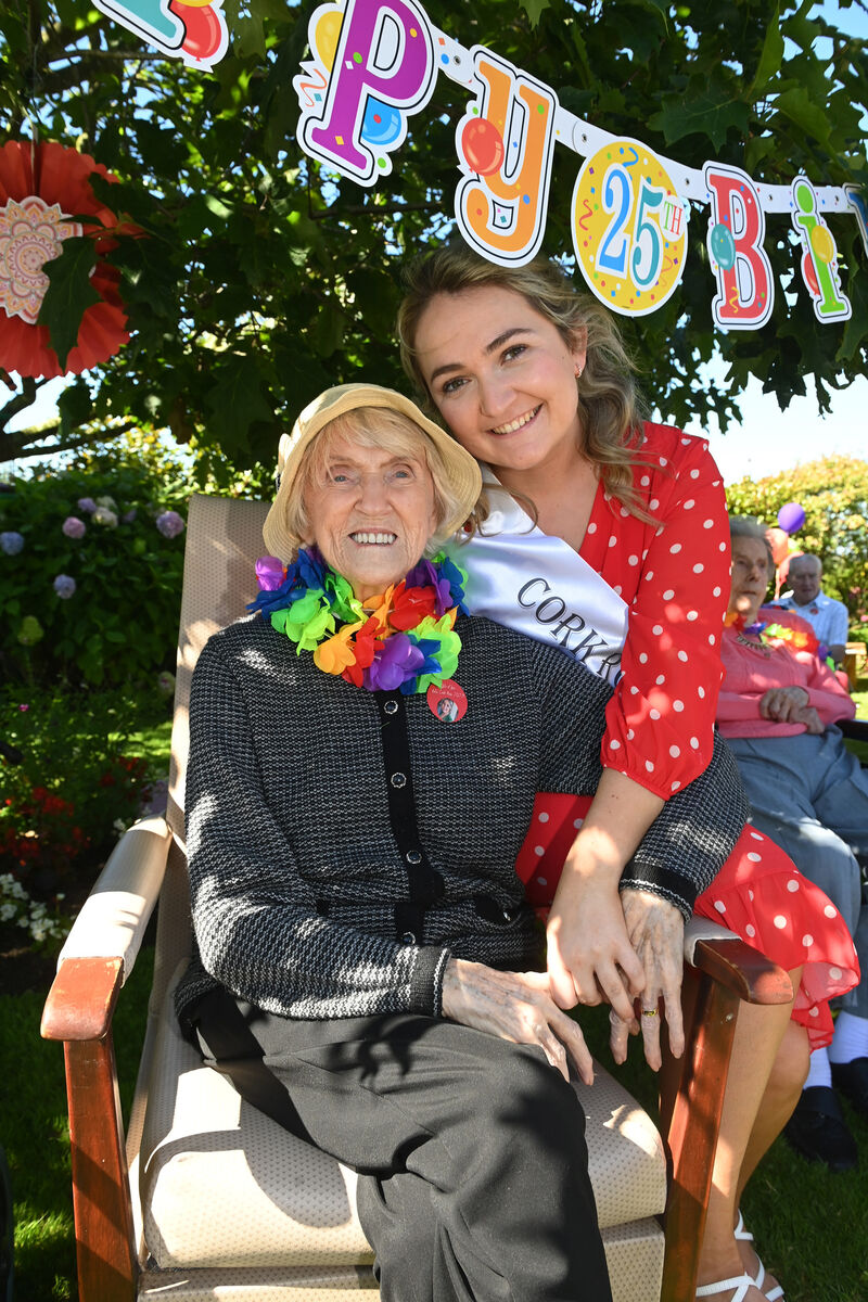 Julia Nason, a ballroom dancer from The Lough, Cork relaxes in the shade with Kate Shaughnessy, staff member at Norwood Grange Nursing Home and Cork Rose 2023 at the Summer Party celebrations on the 25th anniversary of Norwood Grange Nursing Home in Ballinora, Waterfall. Picture: Larry Cummins Julia Nason, a ballroom dancer from The Lough, Cork relaxes in the shade with Kate Shaughnessy, staff member at Norwood Grange Nursing Home and Cork Rose 2023 at the Summer Party celebrations on the 25th anniversary of Norwood Grange Nursing Home in Ballinora, Waterfall. Picture: Larry Cummins