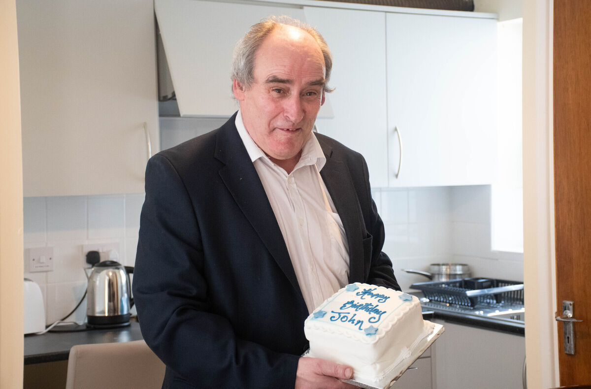 John O'Donnell pictured with his timely birthday cake after moving into his home in Madens Buildings in Blackpool. Picture: Howard Crowdy