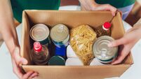 Volunteer with box of food for poor. Donation concept.