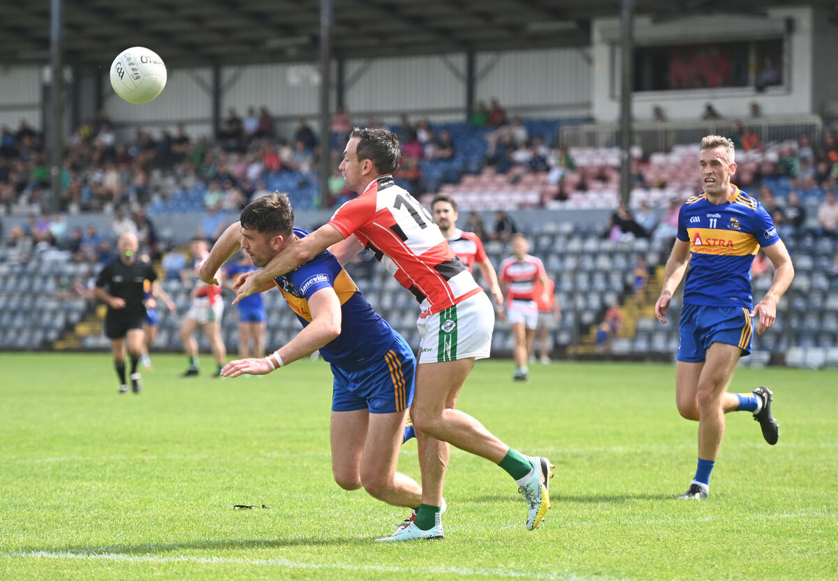  Liam Jennings, Ballincollig tackles Brian Coakley, Carrigaline. Picture: Larry Cummins