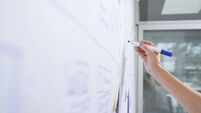 Female entrepreneur drawing on whiteboard
