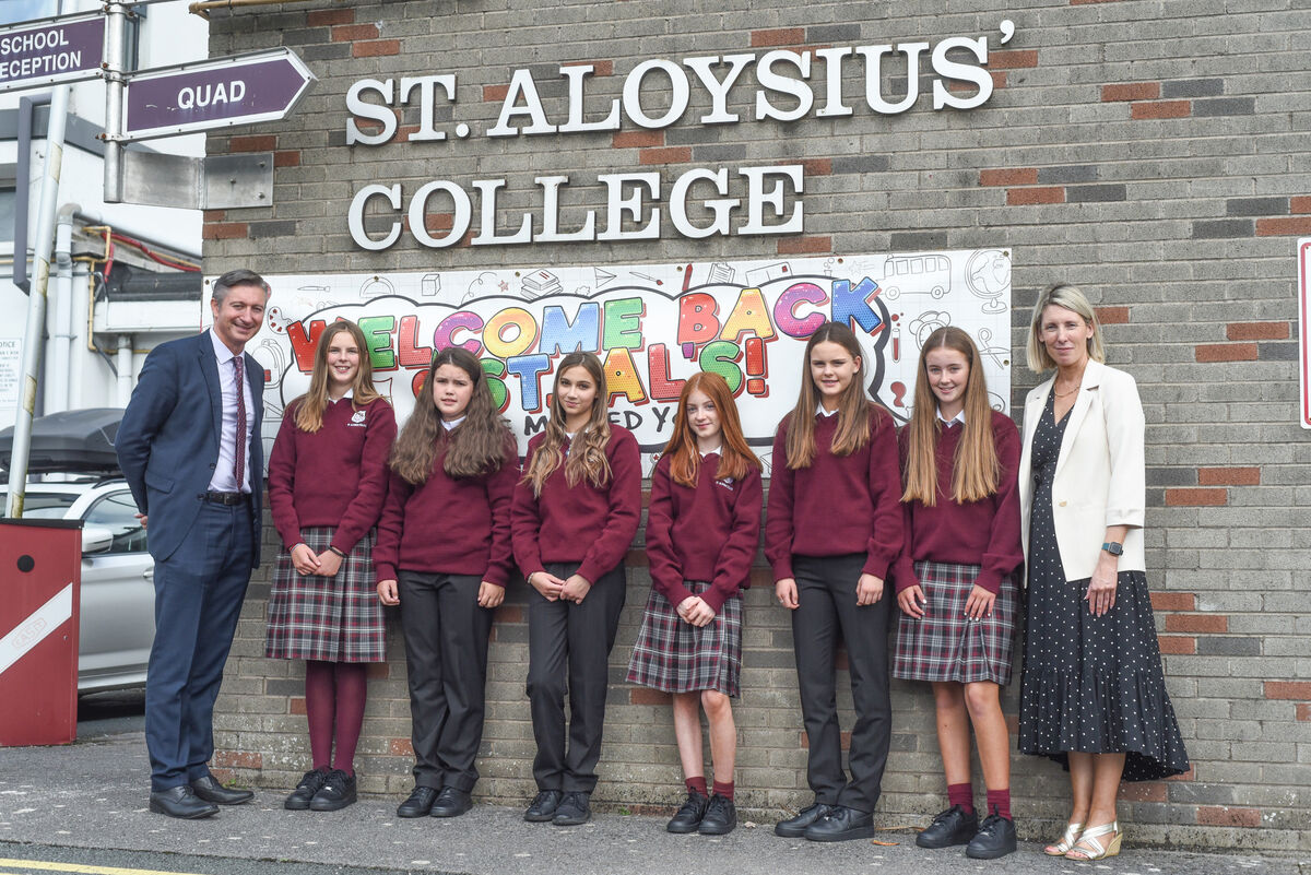 Sean Twomey, Principal of St Aloysius Girls Secondary school in Carrigtwohill, and Ms Manley pose with students on their first day of First Year on Friday. Picture: Cian O'Regan.