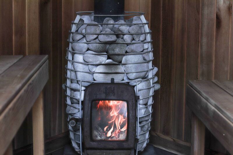  The Fireplace encased with stones in Cedar &amp; Steam Mobile Sauna. Picture: Richard Gordon