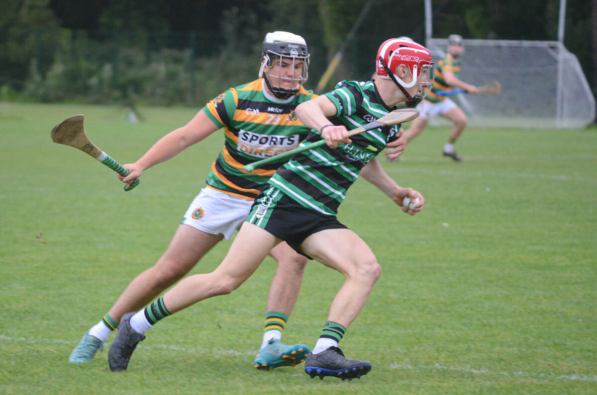 Liam Kelleher of Douglas taking on Craig Hughes of Glen Rovers. Picture: Howard Crowdy
