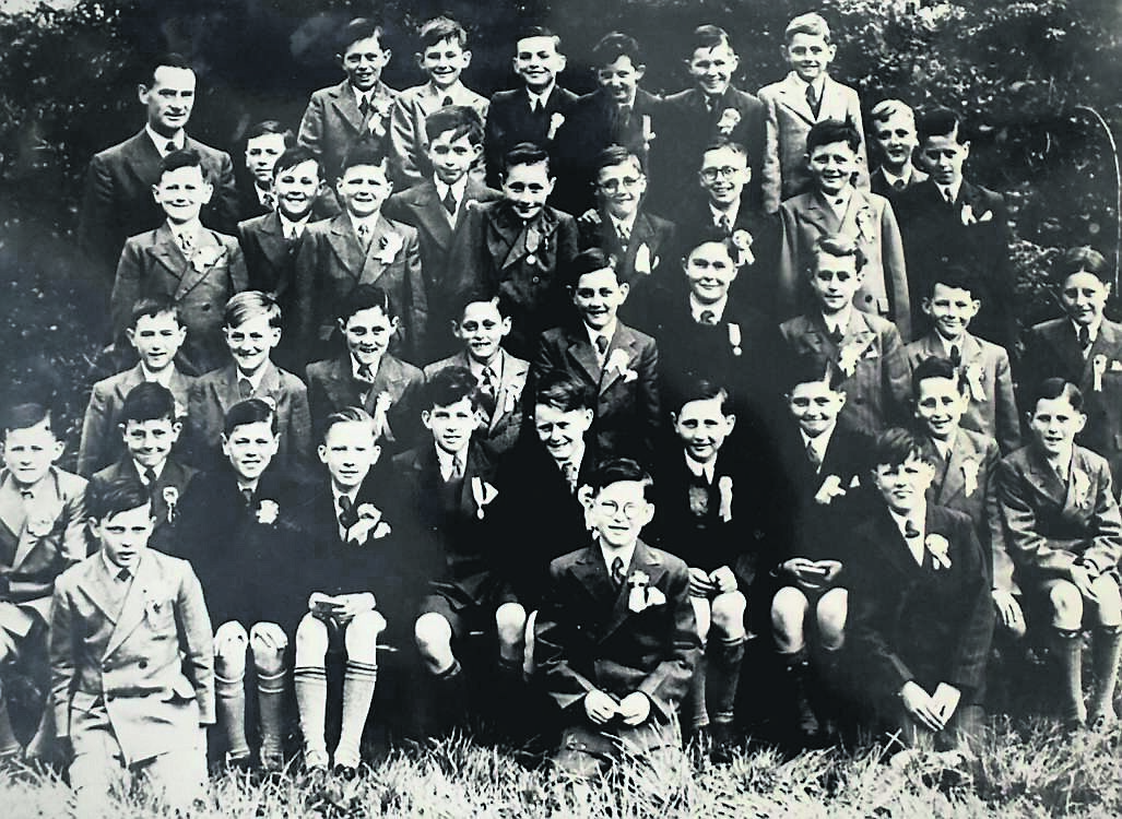 Glasheen NS Confirmation Photo 1953 with teacher Mr Joe Holly. Back row: Martin Mannion, Michael Beamish, Sean O’Sullivan, Eamonn Casey, Pat Duggan, Paddy Tracey. Second row from back: Tommy Lonergan, Dan O’Connor, Paudie Murphy, Jack Matson, Michael Dillane, Billy Murphy, Jack O’Herlihy, Donal Cronin, Richard Dineen, John O’Lehan, Noel Dooley. Third row from back: Anthony O’Connell, Jim Quinn, Gerry Mohally, Con Harrington, Jim Dineen, John Fraher, Michael English, Eddie Finn, Finbarr O’Donovan. Sitting: Michael Bogue, Kieran O’Regan, Hugh Devlin, Noel Daly, Barry Ahern, Denis O’Donovan, Michael O’Mahony, Barry Roche, Finbarr Desmond, Connie Forde. Kneeling: Charlie Coughlan, Con Murphy Alec Rea
