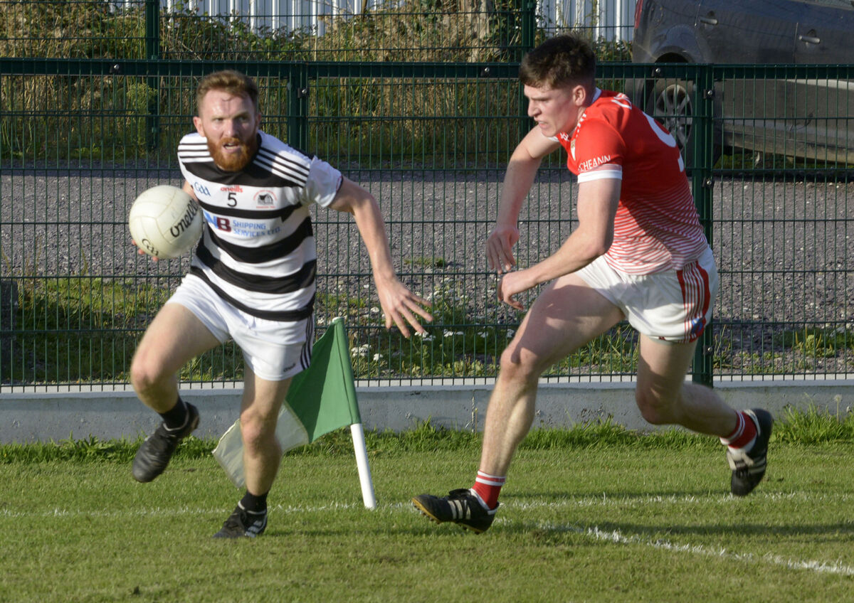 Urhan's Alan O'Sullivan chasing St Nick's David Dunlea. Picture: Denis Boyle