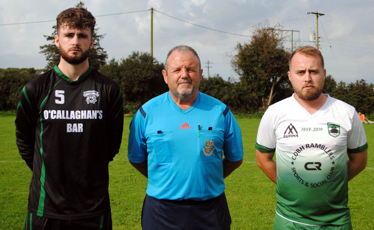 Springfield's captain Leon Keating (right) with Coachford's Mark Murphy, accompanied by referee Paul O'Sullivan.