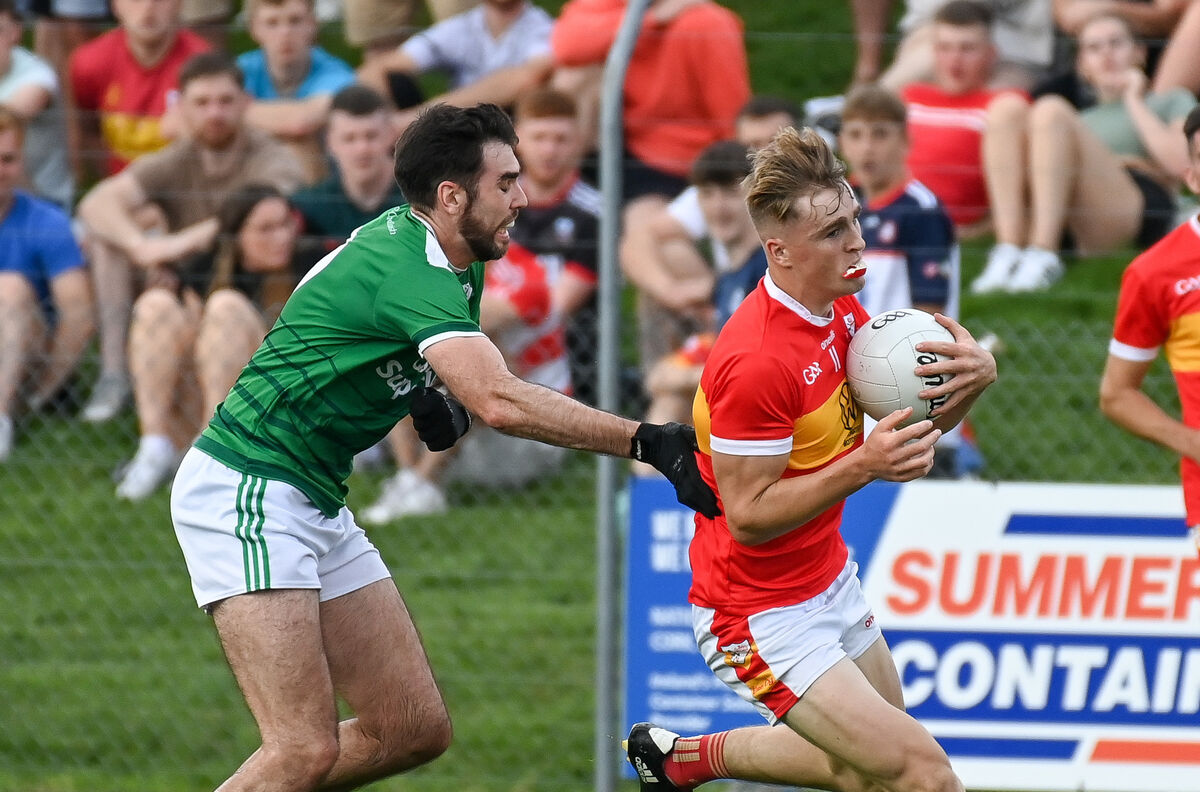 Éire Óg's Joe Cooper is tackled by Ballincollig's Seán Kiely, during their Premier SFC clash at Coachford. Picture: David Keane