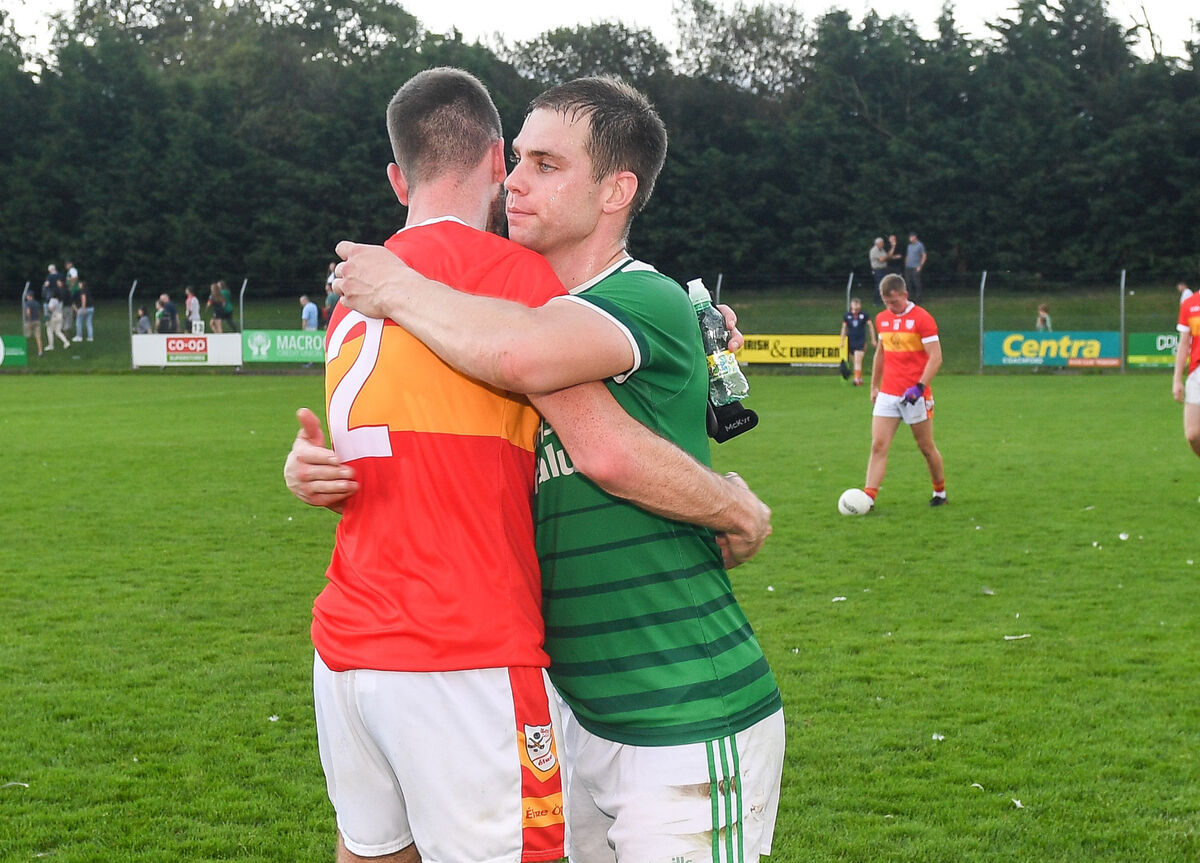 Éire Óg's Michael Corkery is consoled by Ballincollig's Cian Kiely, after their Premier SFC clash at Coachford. Picture: David Keane