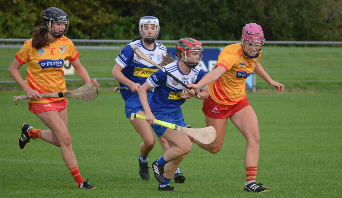 Katie O'Mahony of Inniscarra holds onto the sliothar despite the challenge from Eire Og's Isobel Sheehan during the SE Systems Senior Camogie Championship match at Castle Road. Picture: Howard Crowdy Katie O'Mahony of Inniscarra holds onto the sliothar despite the challenge from Eire Og's Isobel Sheehan during the SE Systems Senior Camogie Championship match at Castle Road. Picture: Howard Crowdy