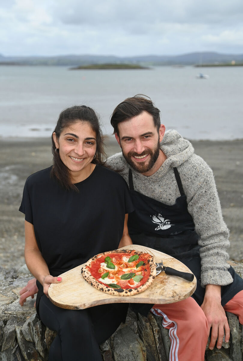 Claudia Meloni and her fiancé Craig Moore with a Caprese pizza from PizzHeiria on Heir Island in West Cork. Picture: Denis Minihane Claudia Meloni and her fiancé Craig Moore with a Caprese pizza from PizzHeiria on Heir Island in West Cork. Picture: Denis Minihane