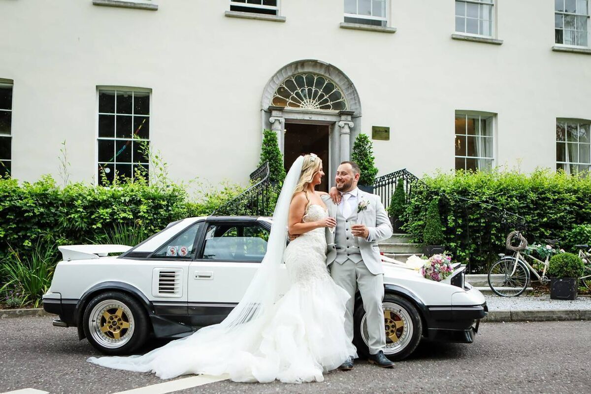 The couple celebrated in style. In the background is one of Danny’s cars, which are his pride and joy and were used on the day.