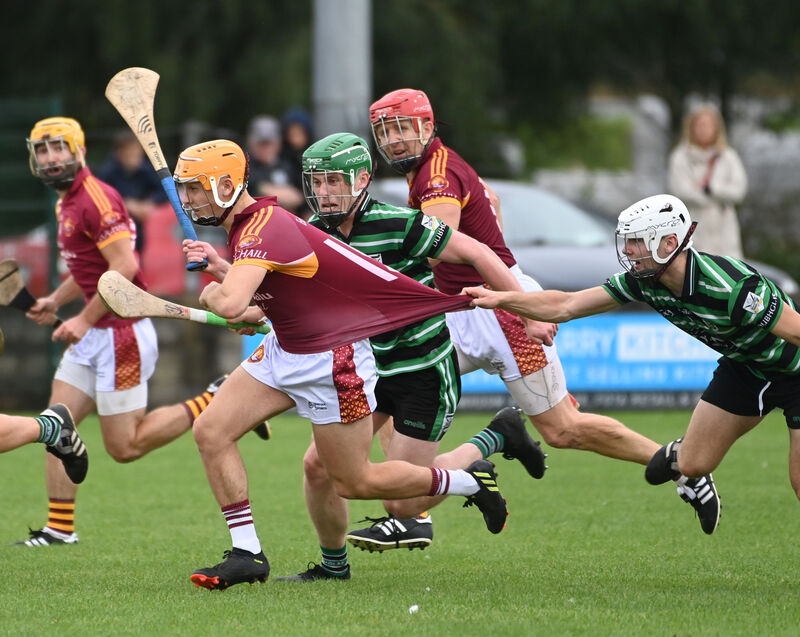 Youghal's Oisin Hill is held by Douglas' Donnacha O'Callaghan. Picture: Eddie O'Hare
