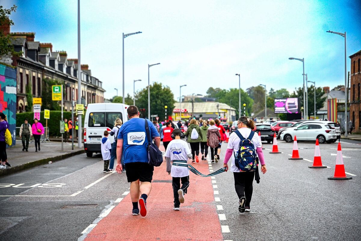  A race for everyone, Rory o’ Neill (11) takes part in the echo mini marathon on behalf of St Gabriel’s Special School, accompanied by Siobhán ands Paul Bridgman. Picture by Chani Anderson