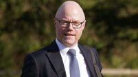 Opposition parties call on Donnelly to return from US amid spinal surgery review